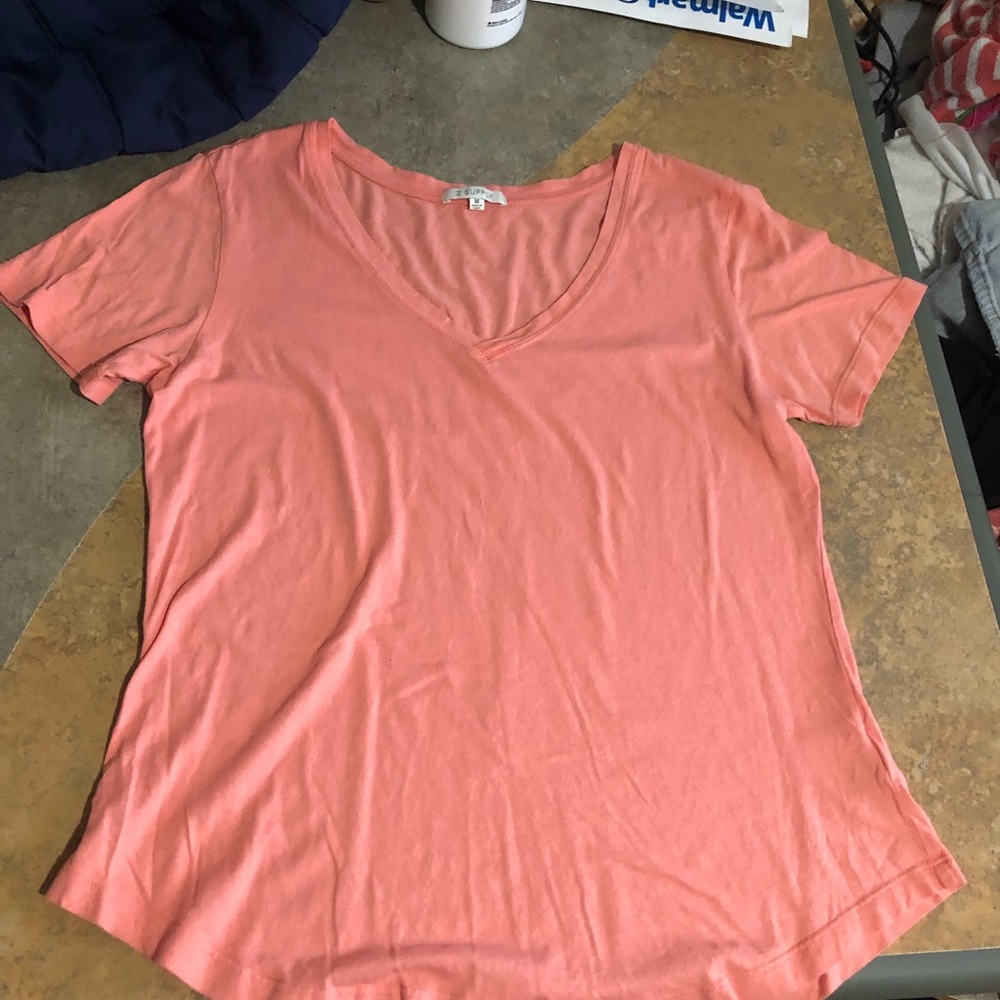 This is a light pink short sleeve light weight tee. New, never worn but no tag.